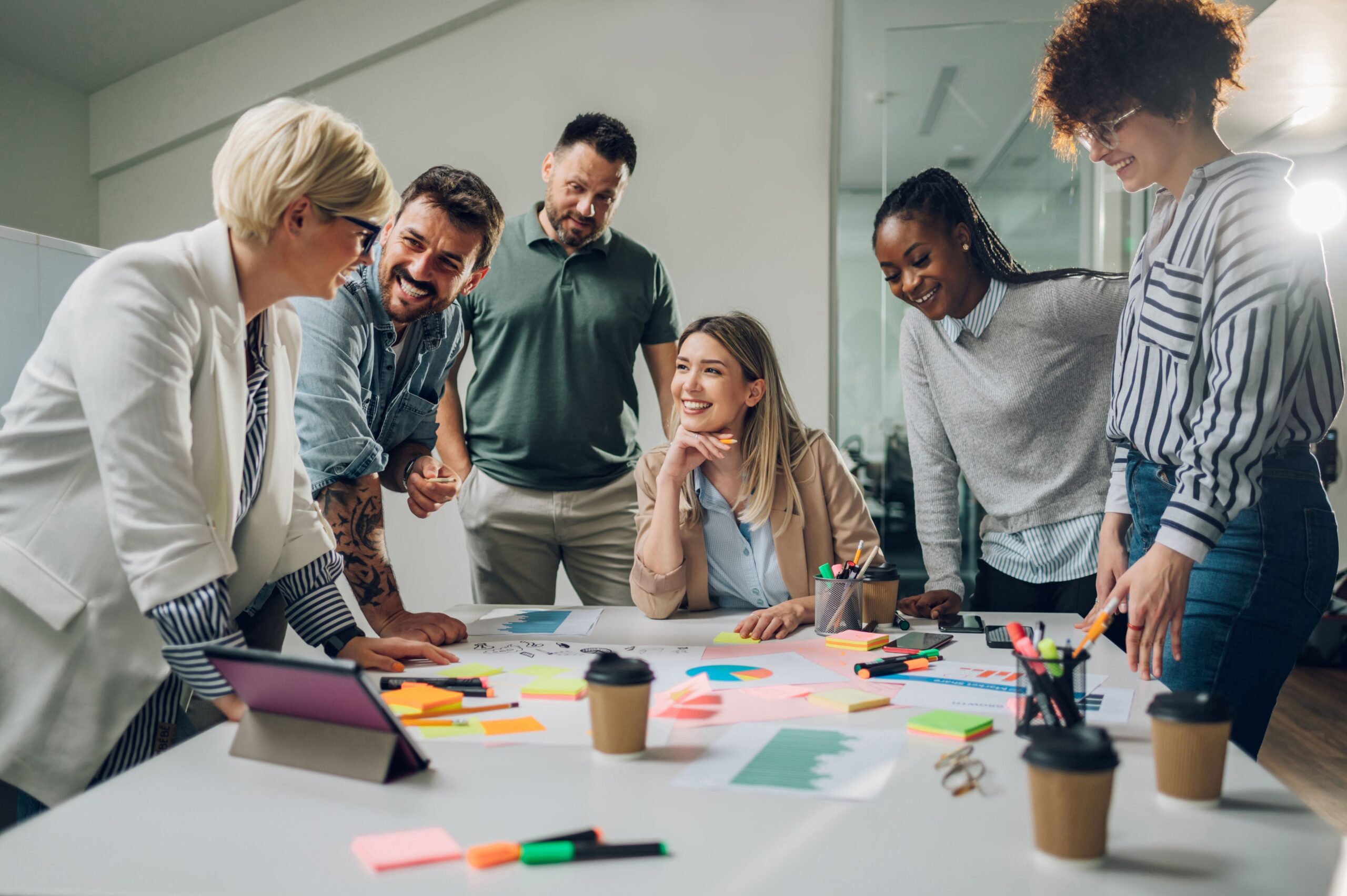 Group smiling and brainstorming in a meeting room