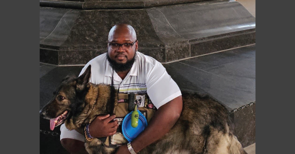 Veteran sitting with his Service Dog