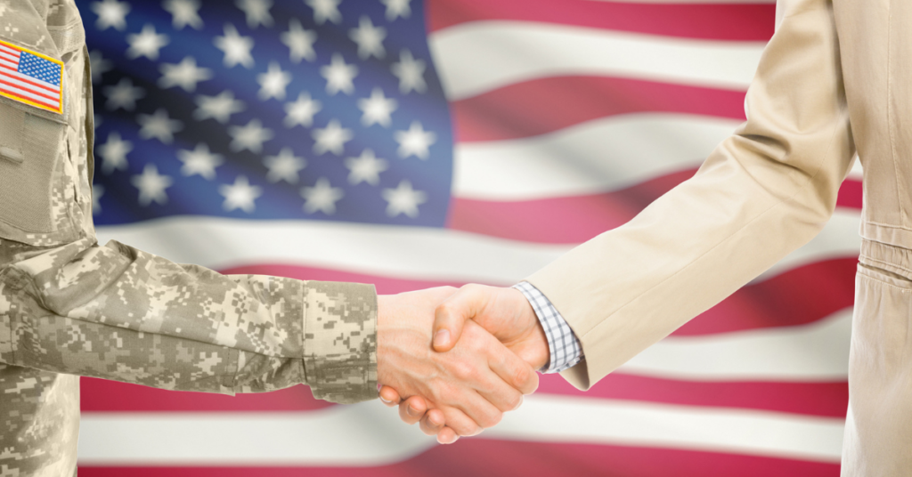 men shaking hands for a new job offer with US flag in background