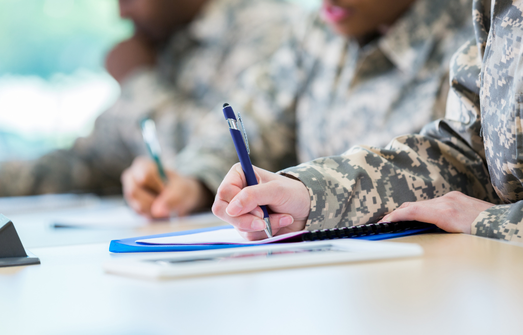 veterans filling out school documents, close up of pen and paper