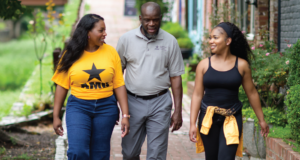 AMU"s Little Family walking together on campus pathway