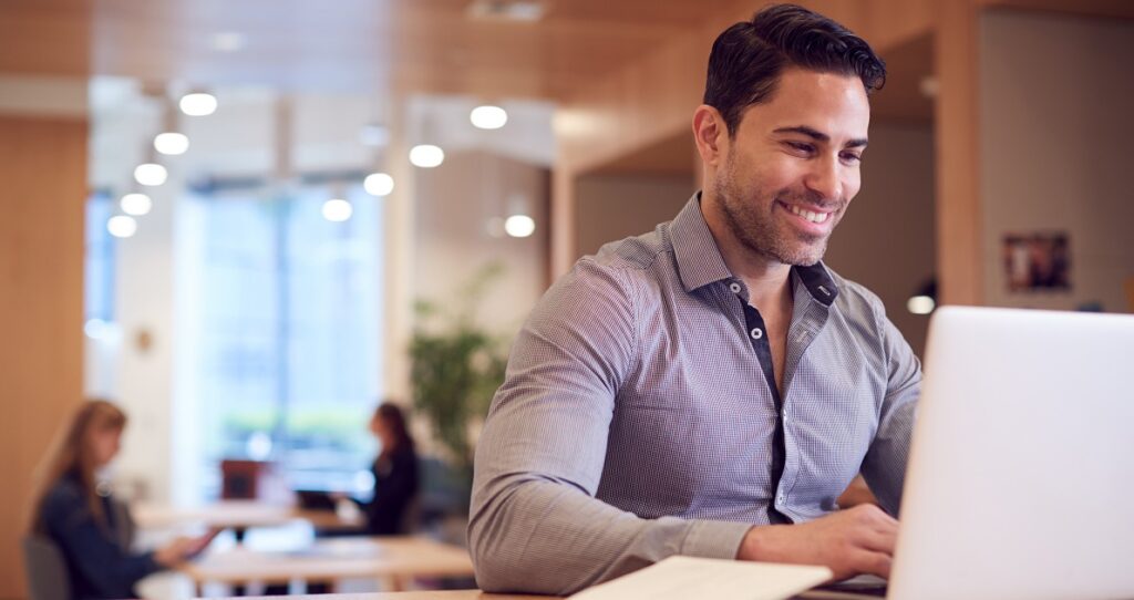 Businessman At Desk In Modern Office Work Space