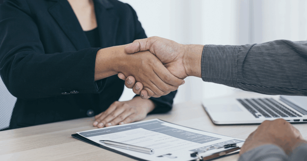 man shaking woman's hand
