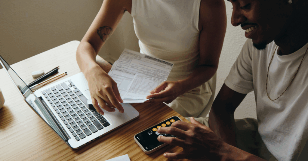couple reviewing documents on paper and the computer