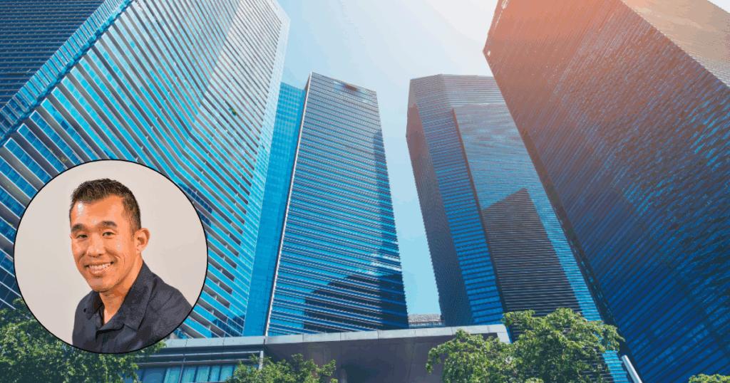 Author Paul Peng with a background of tall buildings