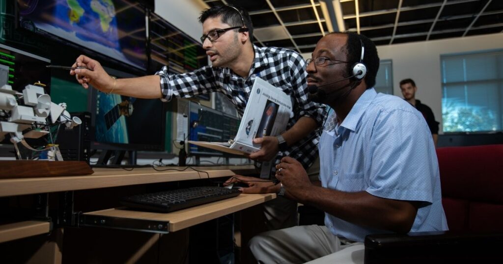 Capitol Tech University: Building the Workforce of the Future Capitol Tech student and teacher look at monitor technical image