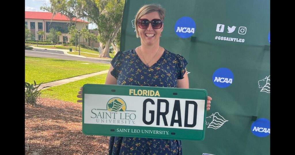 Autumn Church’s Journey: A Veteran’s Path to Purpose at Saint Leo University Autumn Church holding Saint Leo University sign