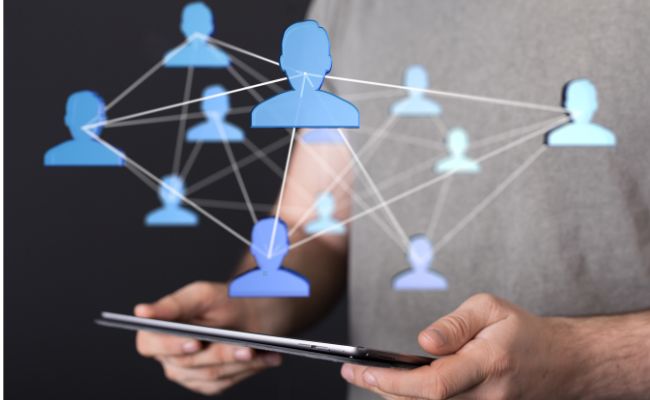 veteran looking at tablet with multi icons of people floating around