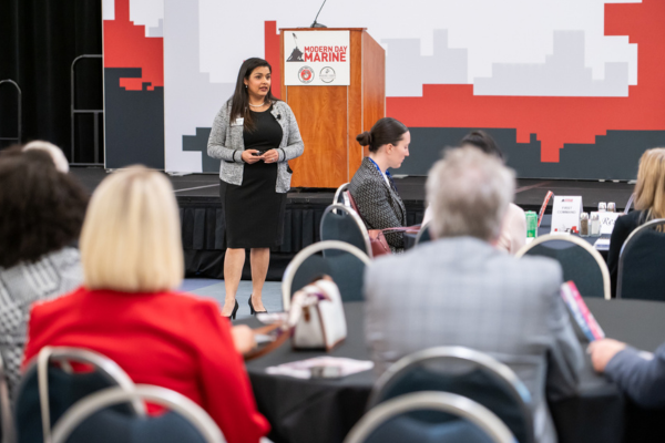 Professional woman addressing audience at a military spouse event